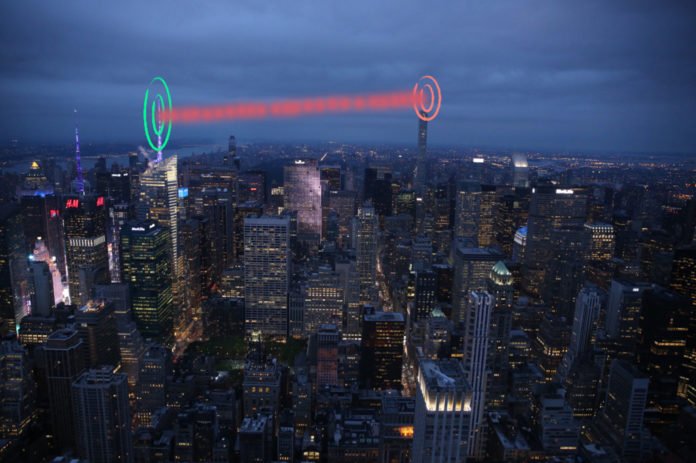 Depiction of the proposed system in a metropolitan city where quantum-secure information is transferred between two quantum nodes.