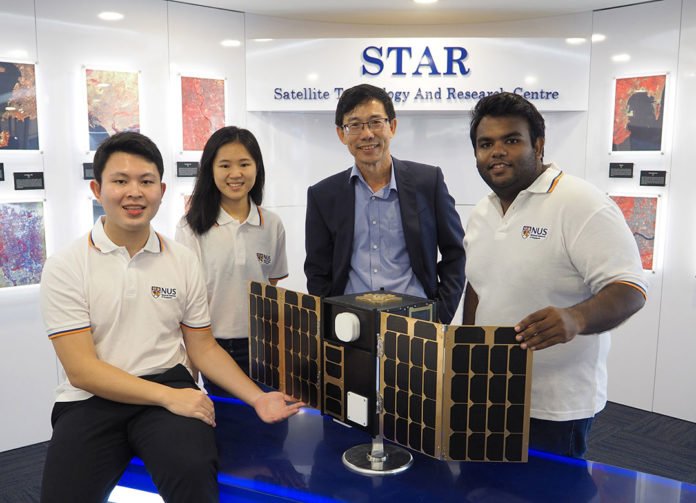 Professor Low Kay Soon (second from right), Director of the Satellite Technology and Research Centre at NUS, together with his students from NUS Engineering. On display is a model of a small satellite that is being developed for applications such as maritime and aviation security.