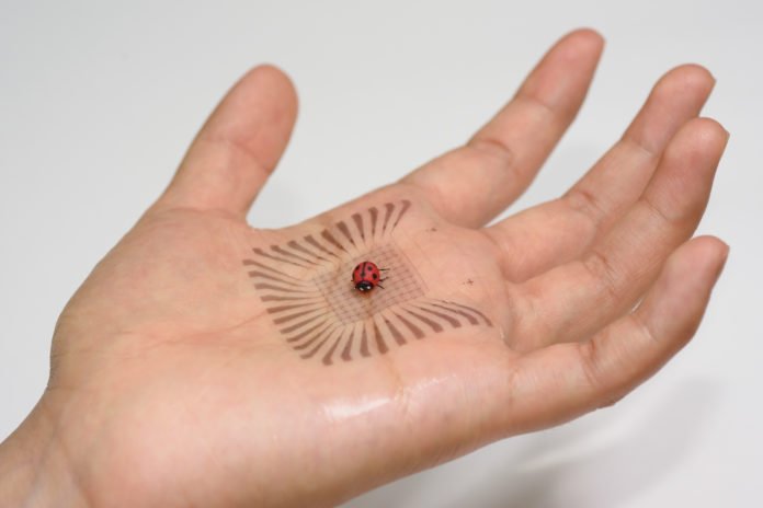 Pixelated electronics built with skin-like materials conform to the complex curves of a hand