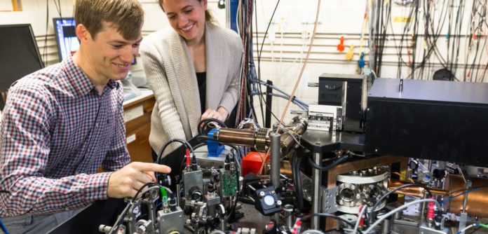 Dr Chris Ballance and Vera Schäfer with ion-trap apparatus in one of Oxford's quantum technology laboratories. Image credit: David Fisher / NQIT