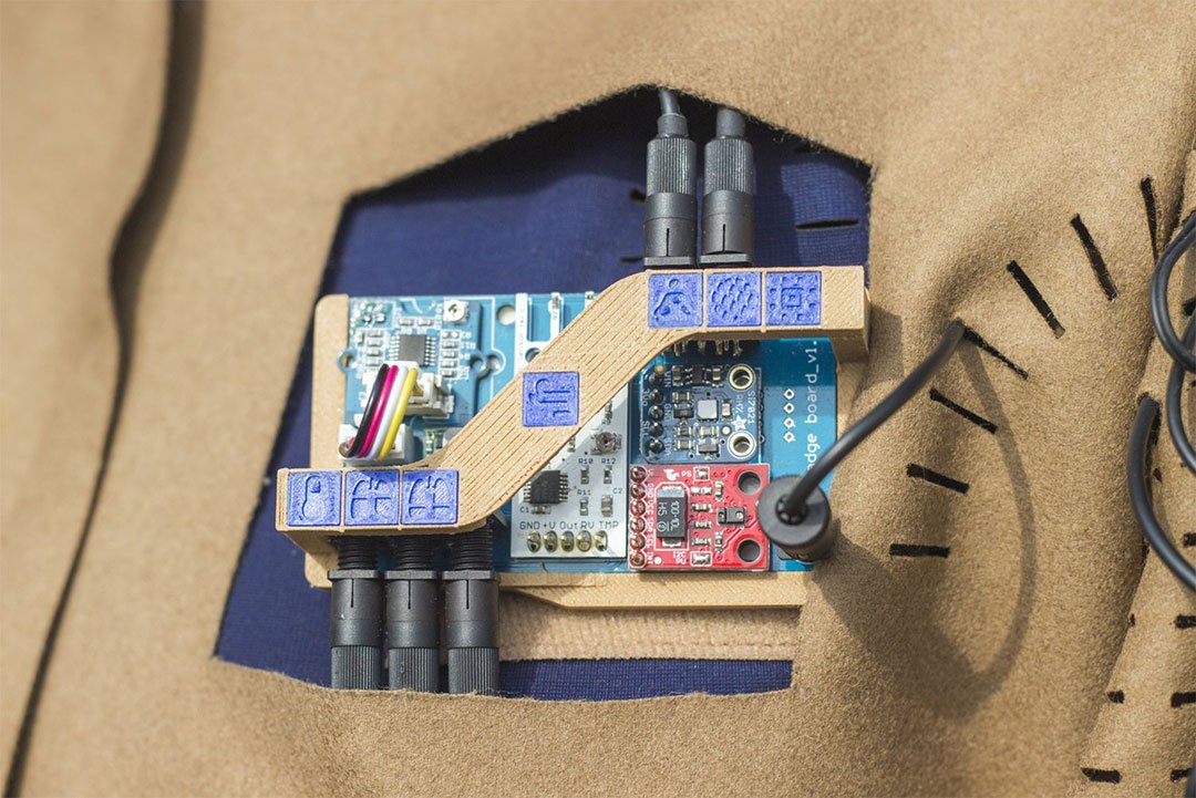 3D prints and laser-cut icons on the meditation suit’s fabric indicate where the sensors and cable connections are located.
