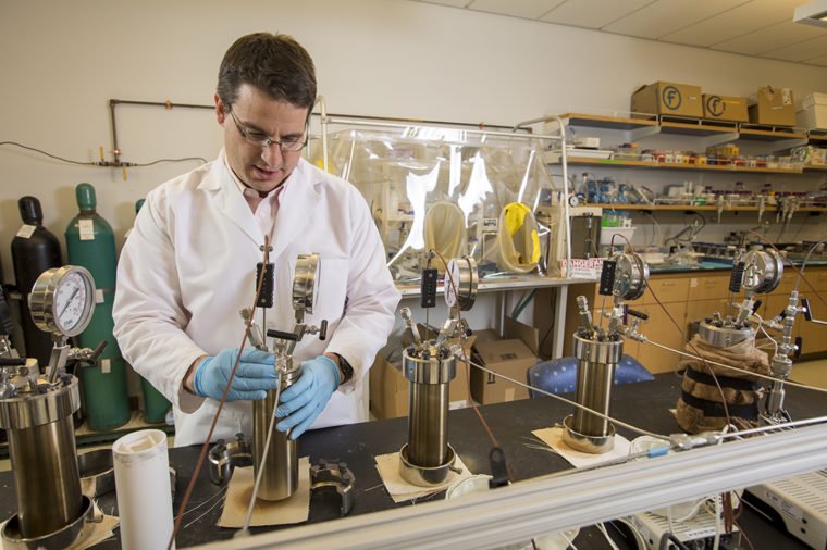 Giammar assembles a stainless steel pressure reactor in his lab. The reactor was designed to simulate conditions deep underground, and test how much CO2 basalt can trap and convert within its pores. (Photo: Joe Angeles/Washington University)