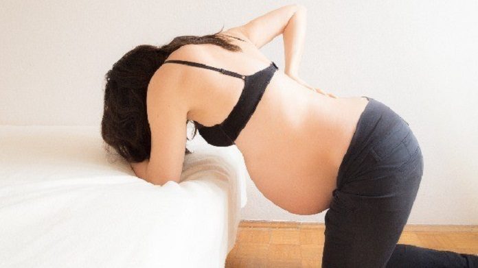 Pregnant woman having contractions in labour pain