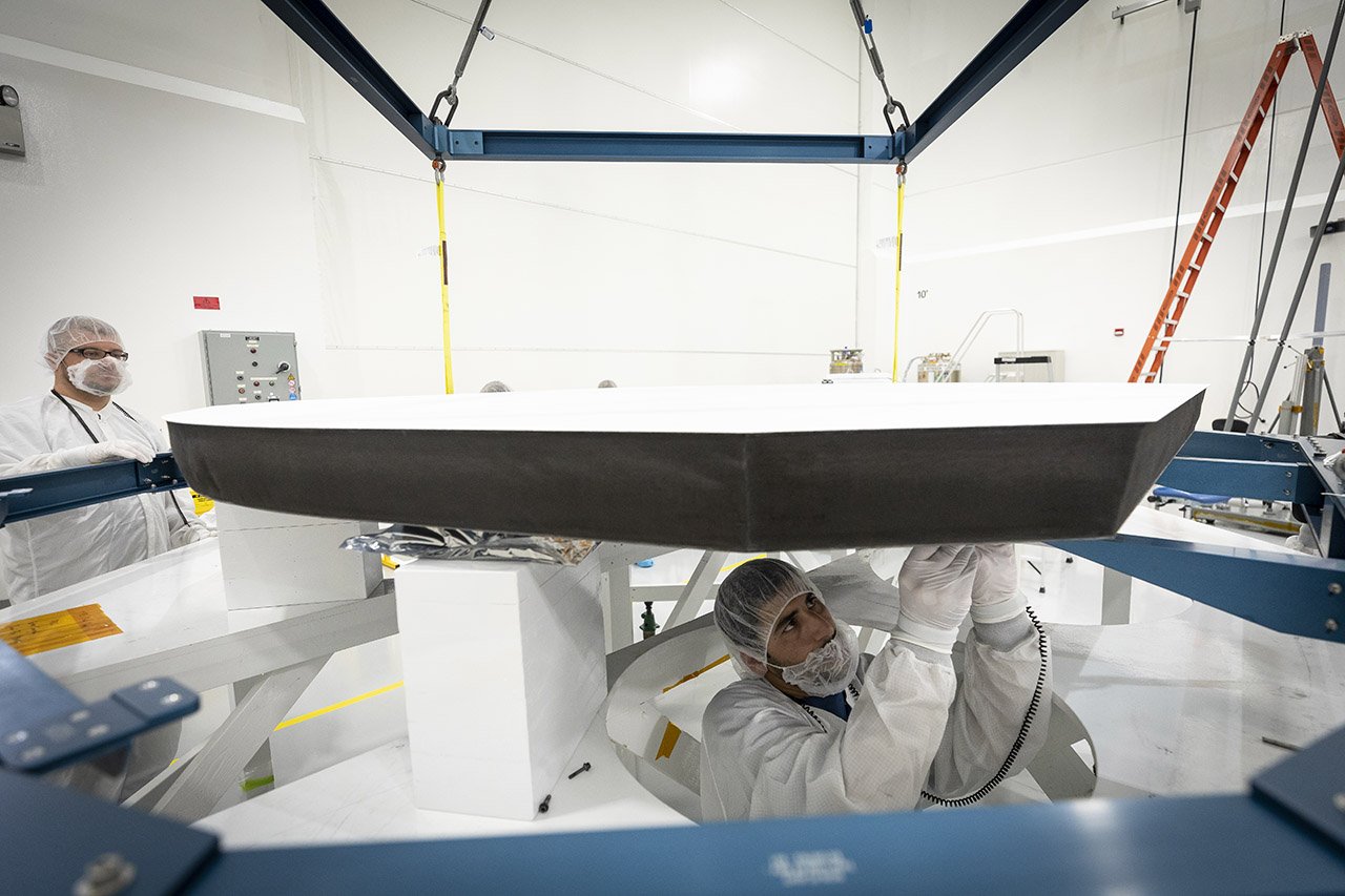 Parker Solar Probe’s heat shield is made of two panels of superheated carbon-carbon composite sandwiching a lightweight 4.5-inch-thick carbon foam core. To reflect as much of the Sun’s energy away from the spacecraft as possible, the Sun-facing side of the heat shield is also sprayed with a specially formulated white coating. Credits: NASA/Johns Hopkins APL/Ed Whitman