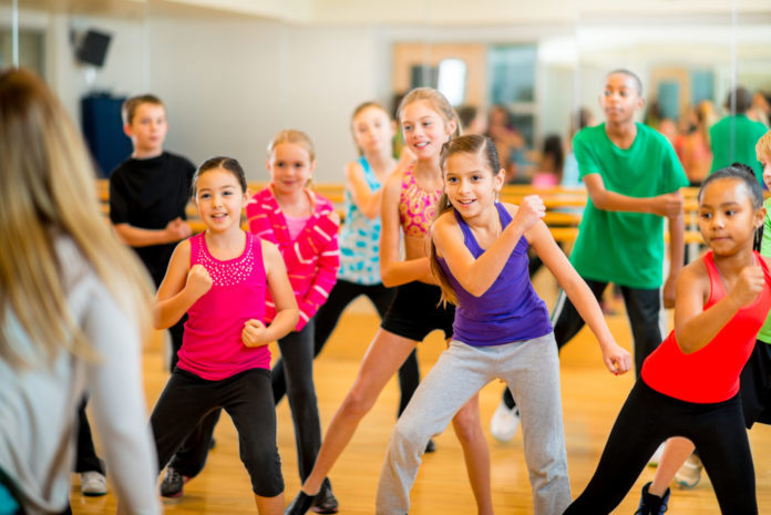 Group of children participating in dance fitness class.
