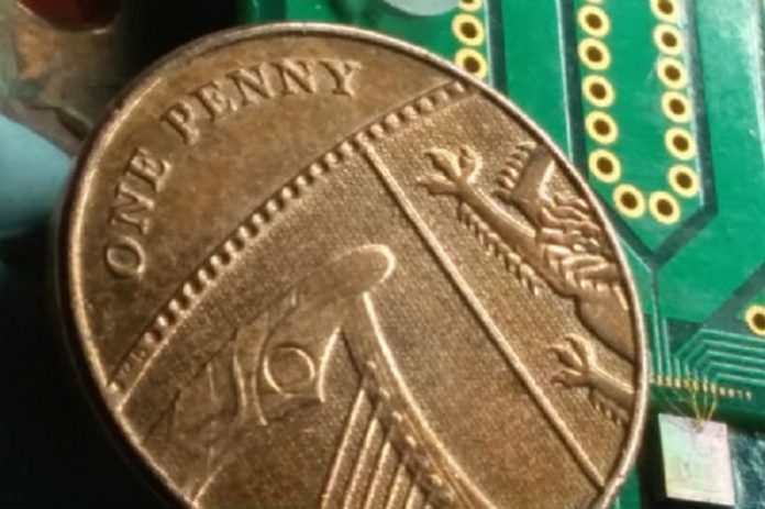 Chip containing all the optical components used to generate quantum-based random numbers at high speed. Here the chip, at the bottom-right corner of the picture, is placed next to a penny coin for comparison. Francesco Raffaelli, University of Bristol