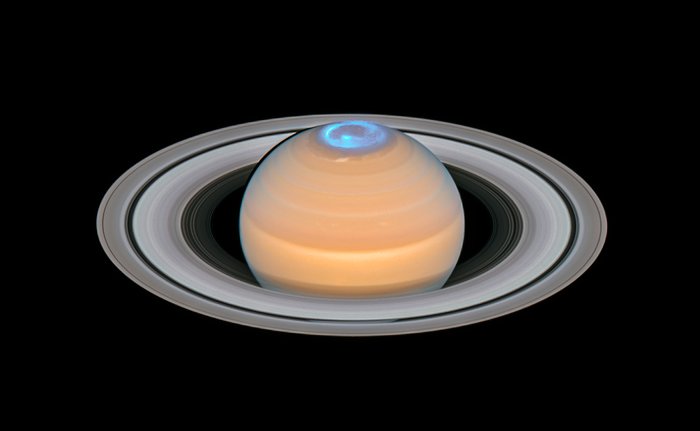 This image is a composite of observations made of Saturn in early 2018 in the optical and of the auroras on Saturn’s north pole region, made in 2017. In contrast to the auroras on Earth the auroras on Saturn are only visible in the ultraviolet — a part of the electromagnetic spectrum blocked by Earth’s atmosphere — and therefore astronomers have to rely on space telescopes like the NASA/ESA Hubble Space Telescope to study them.