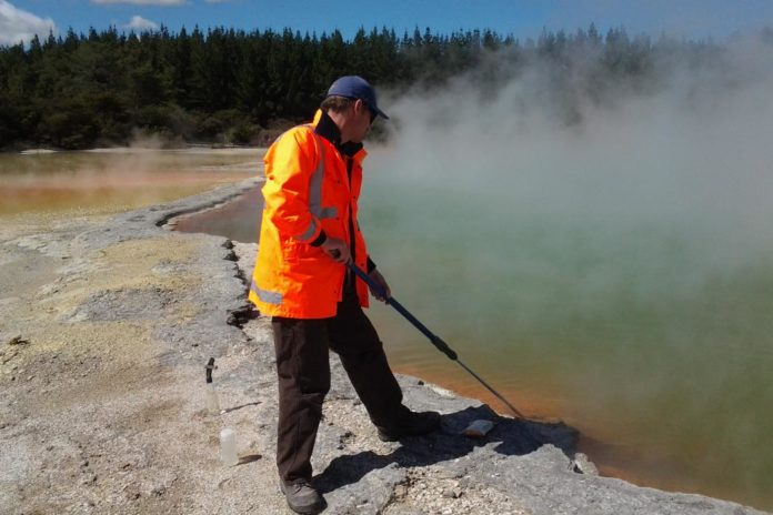 University of Canterbury microbiologist Dr Matthew Stott takes a sample at the Champagne Pool in the Waiotapu geothermal area of the North Island of New Zealand.