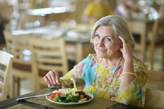 Portrait of beautiful elderly woman in cafe