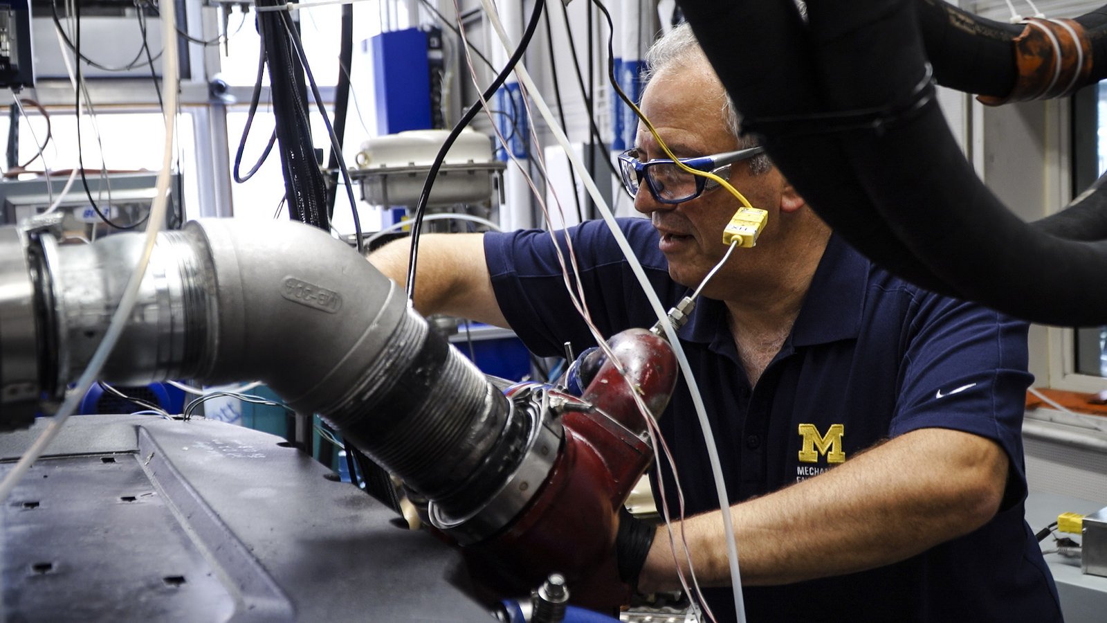 Andre Boehman, professor of mechanical engineering and director of the Walter E. Lay Automotive Laboratory at the University of Michigan, works on a heavy duty single cylinder engine in the auto lab. Image credit: Evan Dougherty, Michigan Engineering