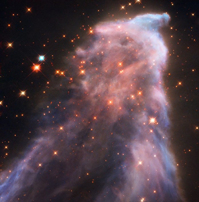 IC 63 — nicknamed the Ghost Nebula — is about 550 light-years from Earth. The nebula is classified as both a reflection nebula — as it is reflecting the light of a nearby star — and as an emission nebula — as it releases hydrogen-alpha radiation. Both effects are caused by the gigantic star Gamma Cassiopeiae. The radiation of this star is also slowly causing the nebula to dissipate. Credit:ESA/Hubble, NASA