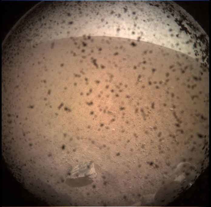 NASA's InSight Mars lander acquired this image of the area in front of the lander using its lander-mounted, Instrument Context Camera (ICC). This image was acquired on Nov. 26, 2018, Sol 0 of the InSight mission where the local mean solar time for the image exposures was 13:34:21. Each ICC image has a field of view of 124 x 124 degrees. Credits: NASA/JPL-CalTech