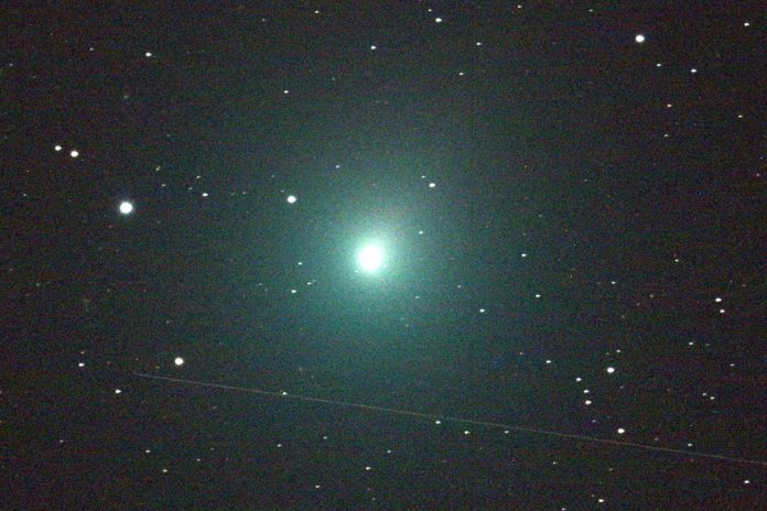 Comet 46P/Wirtanen will be making a close pass of Earth December 16, 2018. It will be at its closest distance to Earth in over four centuries. It is a member of the Jupiter family of comets - their farthest point from the sun being near the orbit of Jupiter. It will be bright enough to see with the naked eye above the eastern horizon all month long, and can be seen even better with a telescope and/or binoculars. This 120 second image of the comet was taken Dec. 2 by an iTelescope 50 mm refractor located at an observatory near Mayhill, New Mexico. The streak below the comet was produced by a rocket body (upper stage) passing through the telescope's field of view during the exposure. Specifically, the upper stage is the one that placed the Indonesian Garuda 1 communications satellite into geostationary orbit back in February of 2000. At the time of this image, the Garuda 1 upper stage was 15,880 miles from the observatory; Comet Wirtanen was 10.3 million miles distant. Image Credit: NASA