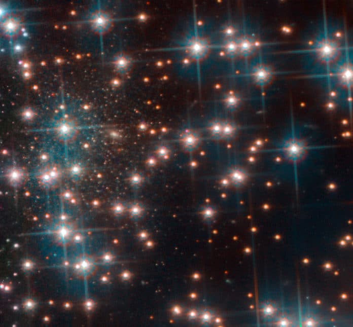 This image, taken with Hubble’s Advanced Camera for Surveys shows a part the globular cluster NGC 6752. Behind the bright stars of the cluster a denser collection of faint stars is visible — a previously unknown dwarf spheroidal galaxy. This galaxy, nicknamed Bedin 1, is about 30 million light-years from Earth. Credit: ESA/Hubble, NASA, Bedin et al.
