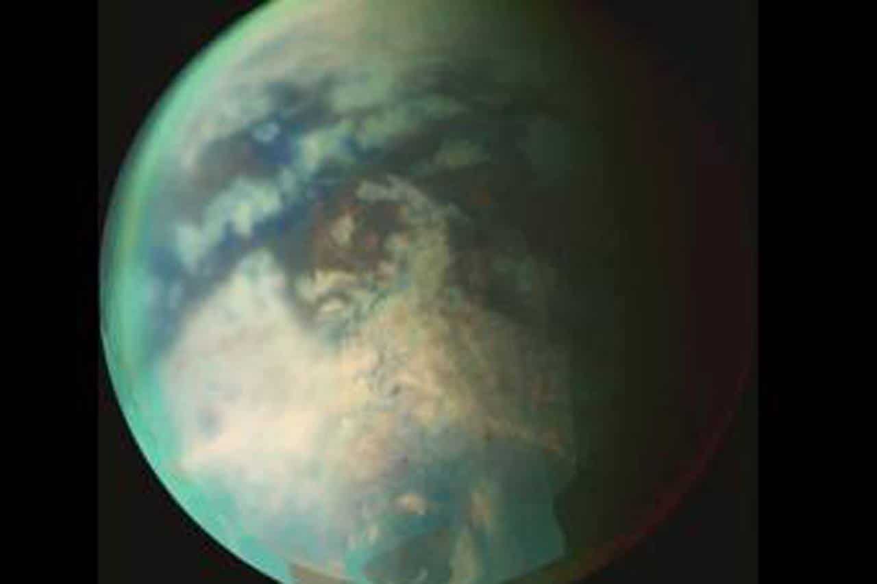 New research provides evidence of rainfall on the north pole of Titan, the largest of Saturn’s moons, shown here. The rainfall would be the first indication of the start of a summer season in the moon’s northern hemisphere, according to the researchers. Credit: NASA/JPL/University of Arizona.