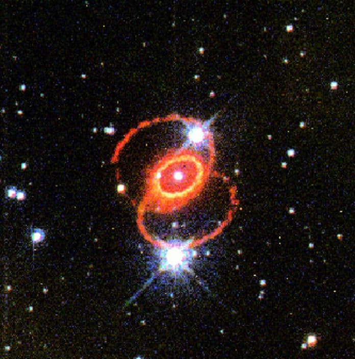 This image, taken with Hubble's Wide Field and Planetary Camera 2in 1995, shows the orange-red rings surrounding Supernova 1987A in the Large Magellanic Cloud. The glowing debris of the supernova explosion, which occurred in February 1987, is at the center of the inner ring. The small white square indicates the location of the STIS aperture used for the new far-ultraviolet observation.