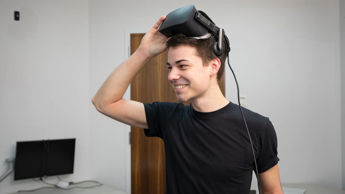 Doctoral candidate Jack Madden removes VR goggles.