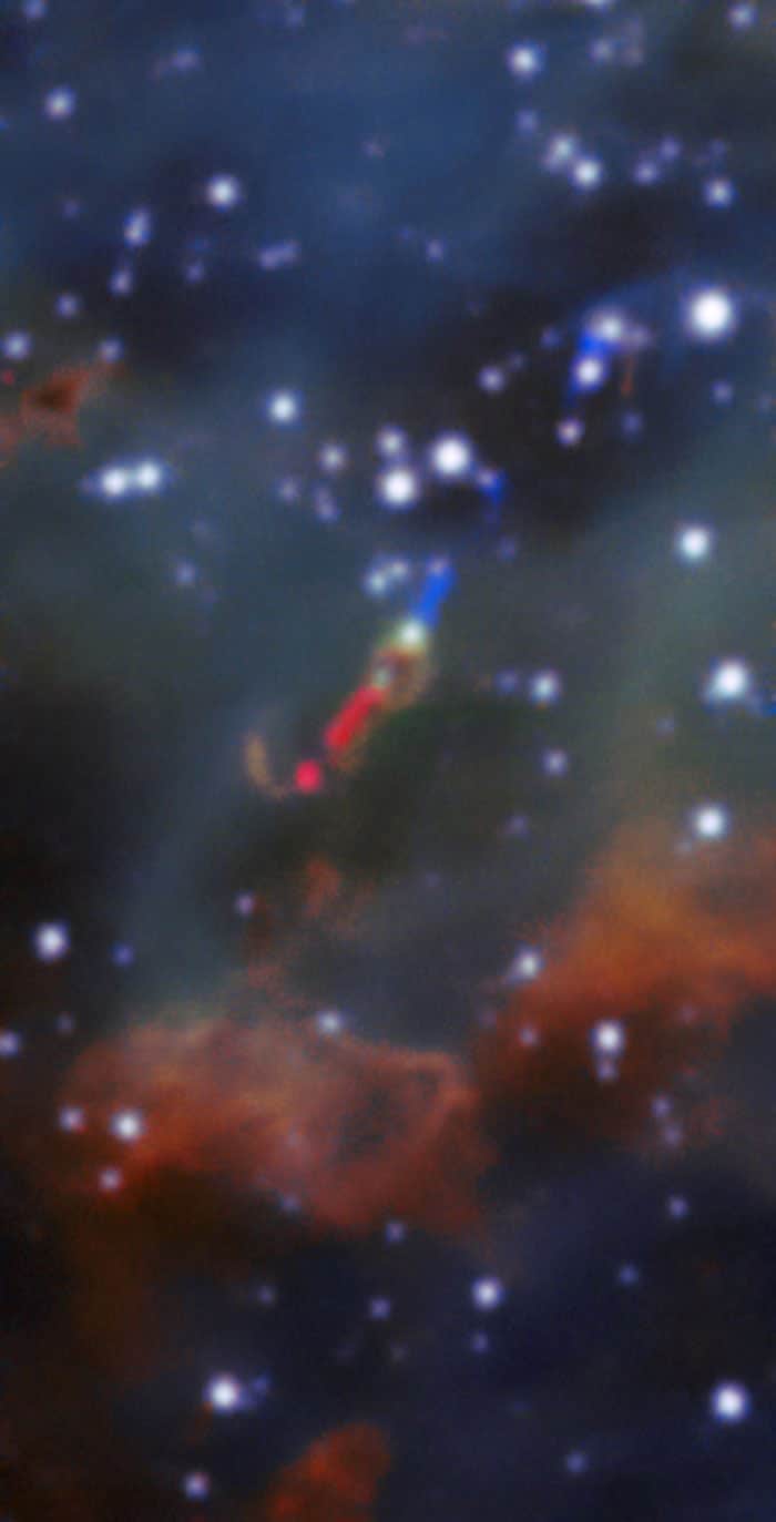 Deep within the glowing cloud of the HII region LHA 120-N 180B, MUSE has spotted a jet emitted by a fledgling star — a massive young stellar object . This is the first time such a jet has been observed in visible light outside the Milky Way. Usually, such jets are obscured by their dusty surroundings, meaning they can only be detected at infrared or radio wavelengths by telescopes such as ALMA. However, the relatively dust-free environment of the LMC allowed this jet — named Herbig–Haro 1177, or HH 1177 for short — to be observed at visible wavelengths. At nearly 33 light-years in length, it is one of the longest such jets ever observed.  The blue and red regions in this image show the jet, which was detected as blue- and red-shifted emission peaks of the Hα line.  Credit: ESO, A McLeod et al.