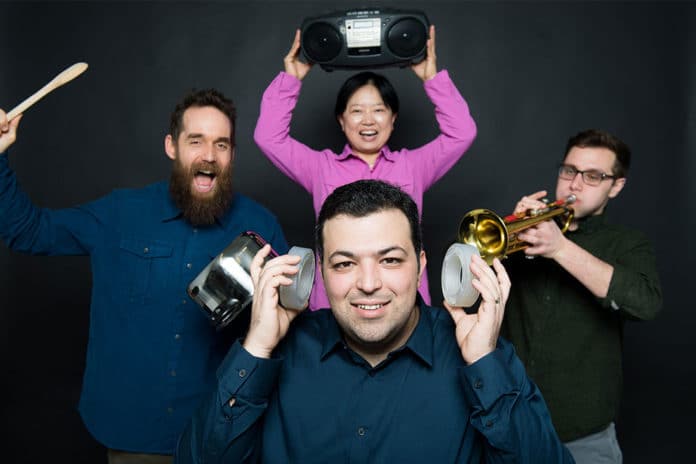 Boston University mechanical engineers have created synthetic, sound-silencing structures—acoustic metamaterials—that can block 94% of sounds. Reza Ghaffarivardavagh (ENG) (front center) holds two of the open, ringlike structures over his ears while Stephan Anderson (MED) (left), Xin Zhang (ENG) (rear center), and Jacob Nikolajczyk (ENG) (right) make a racket. Photo by Cydney Scott