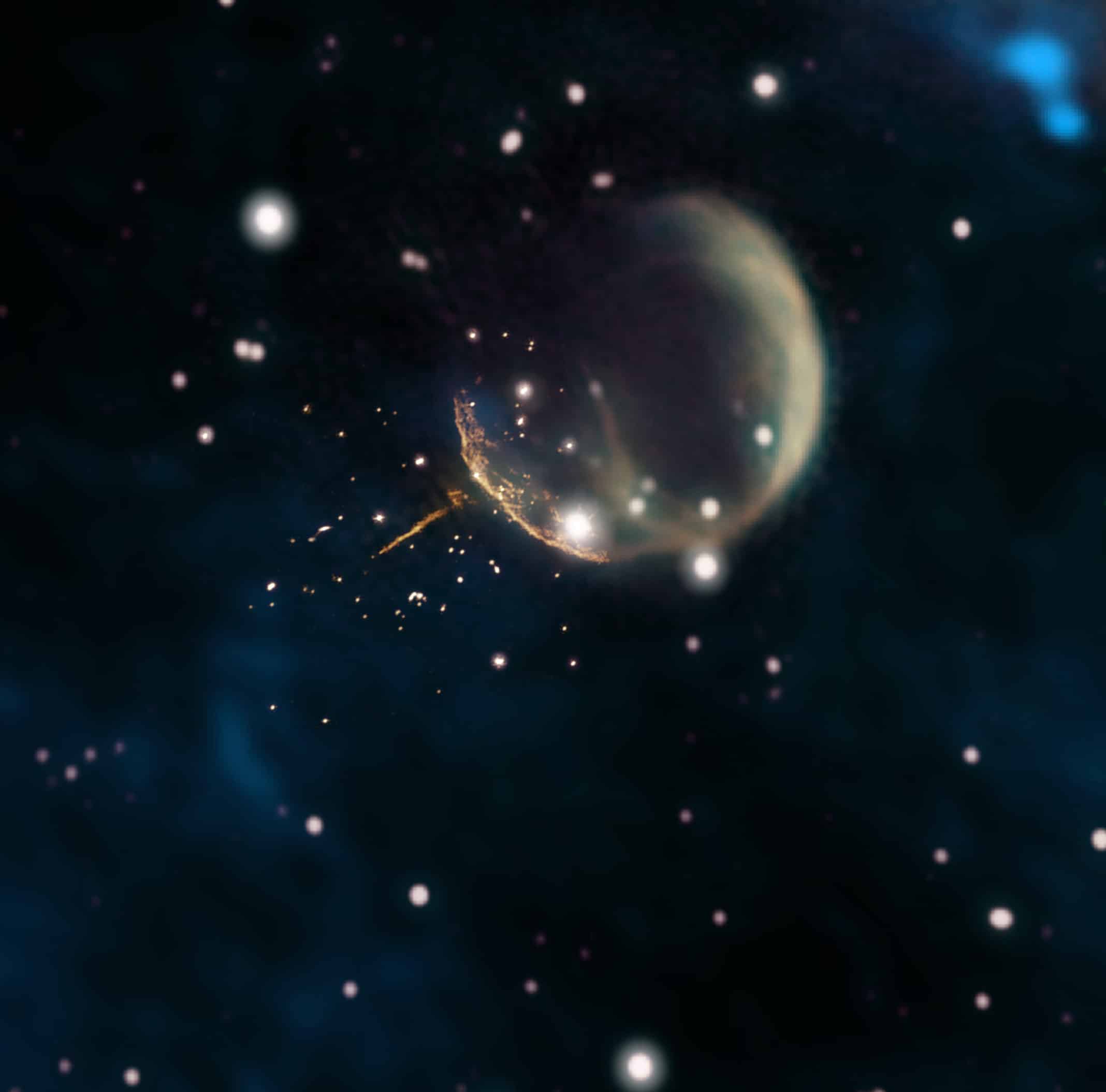 The CTB 1 supernova remnant resembles a ghostly bubble in this image, which combines new 1.5 gigahertz observations from the Very Large Array (VLA) radio telescope (orange, near center) with older observations from the Dominion Radio Astrophysical Observatory’s Canadian Galactic Plane Survey (1.42 gigahertz, magenta and yellow; 408 megahertz, green) and infrared data (blue). The VLA data clearly reveal the straight, glowing trail from pulsar J0002+6216 and the curved rim of the remnant’s shell. CTB 1 is about half a degree across, the apparent size of a full Moon. Credits: Composite by Jayanne English, University of Manitoba, using data from NRAO/F. Schinzel et al., DRAO/Canadian Galactic Plane Survey and NASA/IRAS