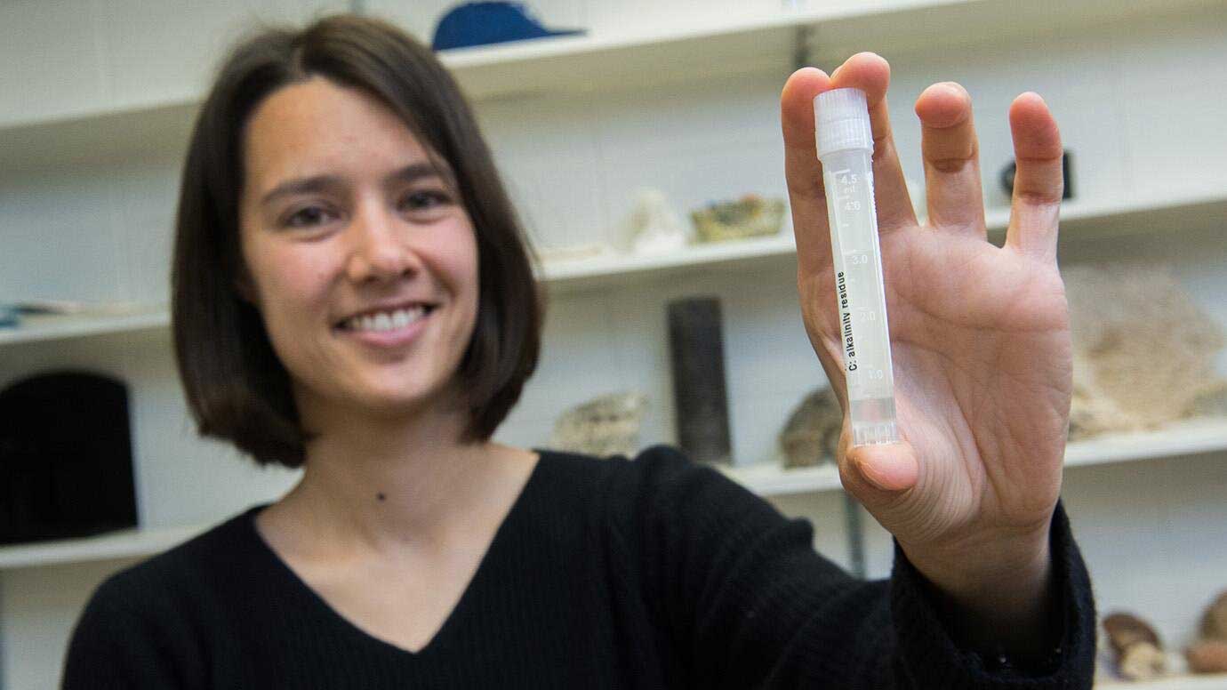 Assistant Professor Clara Blättler with a vial of seawater dating to the last Ice Age—about 20,000 years ago. Credit: Jean Lachat