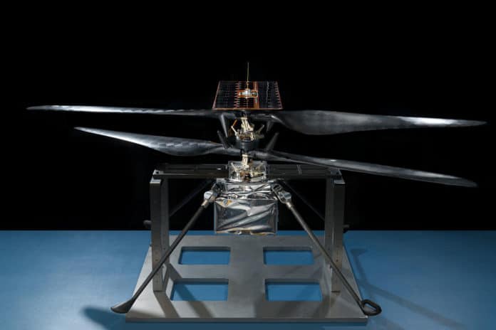 This image of the flight model of NASA's Mars Helicopter was taken on Feb. 14, 2019, in a cleanroom at NASA's Jet Propulsion Laboratory in Pasadena, California. The aluminum base plate, side posts, and crossbeam around the helicopter protect the helicopter's landing legs and the attachment points that will hold it to the belly of the Mars 2020 rover. Image Credit: NASA/JPL-Caltech