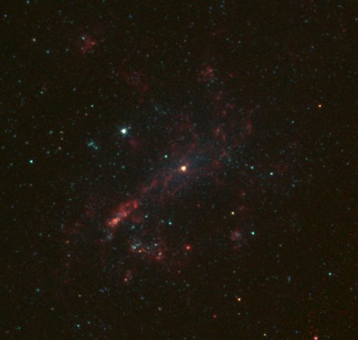 NASA's Spitzer Space Telescope captures galaxy NGC 4395 in infrared light. NGC 4395 is about 1,000 times smaller than the Milky Way, and a team of astronomers including U-M's Elena Gallo has determined the mass of the black hole at its center. CREDIT NASA