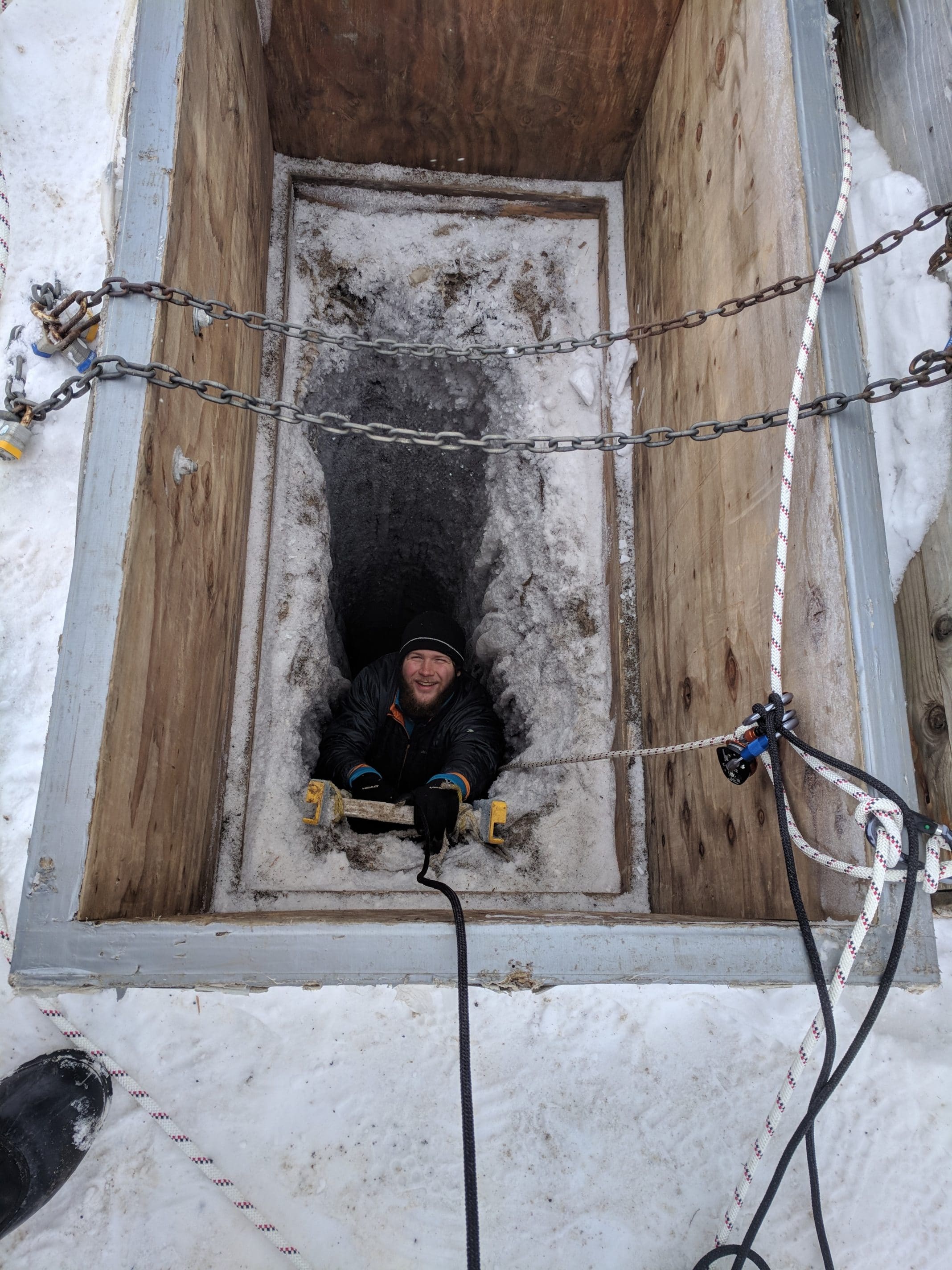 Oceanography graduate student Zac Cooper climbs down an icy ladder into the tunnel in May 2018. Researchers are harnessed to a rope for safety.Shelly Carpenter/University of Washington