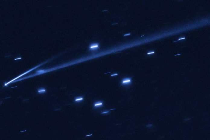 The asteroid 6478 Gault is seen with the NASA/ESA Hubble Space Telescope, showing two narrow, comet-like tails of debris that tell us that the asteroid is slowly undergoing self-destruction. The bright streaks surrounding the asteroid are background stars. The Gault asteroid is located between the orbits of Mars and Jupiter.