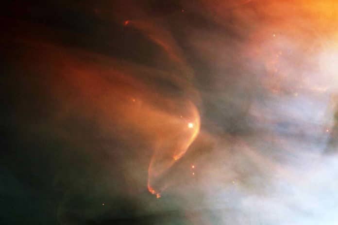 An example of an interstellar collisionless shock is seen in this photo of a bow shock in the Orion Nebula. Image credit: NASA and the Hubble Heritage Team (STScI/AURA)