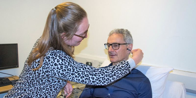 Dr Beatrice Bretherton sets up the tVNS therapy for a volunteer. Image Credit: University of Leeds