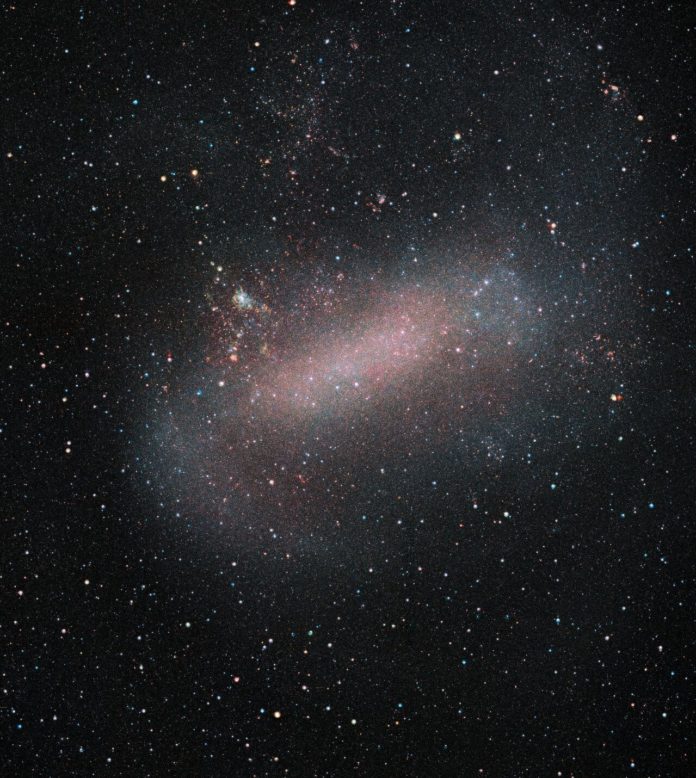 ESO’s VISTA telescope reveals a remarkable image of the Large Magellanic Cloud, one of our nearest galactic neighbours. VISTA has been surveying this galaxy and its sibling the Small Magellanic Cloud, as well as their surroundings, in unprecedented detail. This survey allows astronomers to observe a large number of stars, opening up new opportunities to study stellar evolution, galactic dynamics, and variable stars. Credit: ESO/VMC Survey