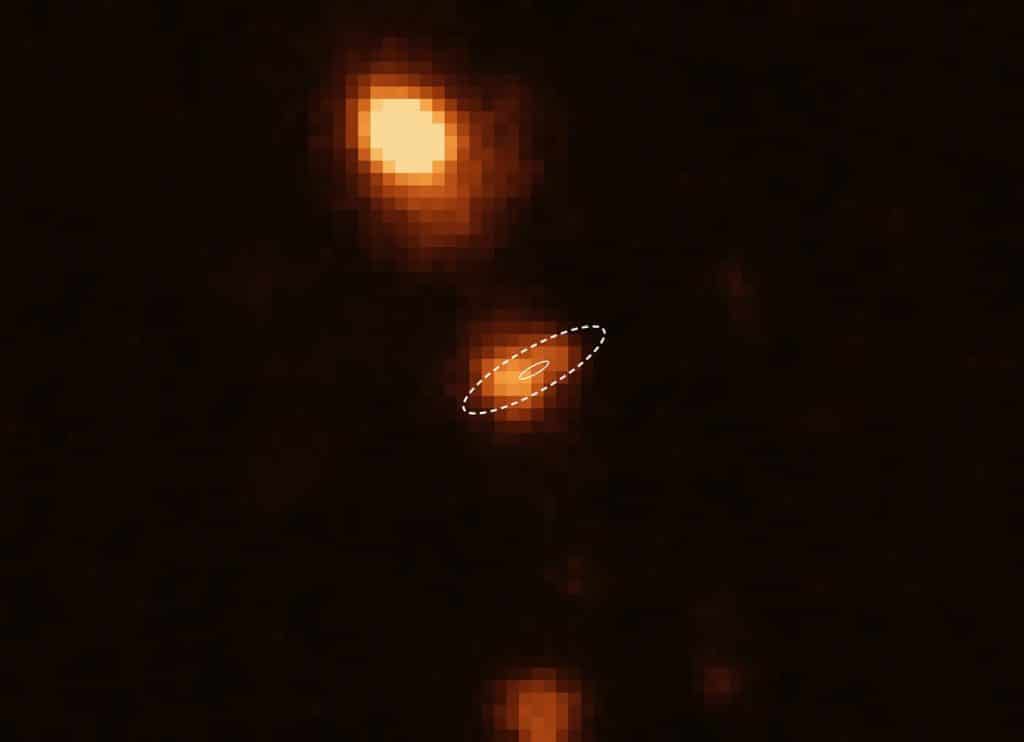 Soon after the Australian Square Kilometre Array Pathfinder (ASKAP) radio telescope pinpointed a fast radio burst, named FRB 181112, ESO’s Very Large Telescope (VLT) took this image and other data to determine the distance to its host galaxy (FRB 181112 location indicated by the white ellipses). The analysis of these data revealed that the radio pulses have passed through the halo of a massive galaxy (at the top of the image) on their way toward Earth. Credit: ESO/X. Prochaska et al.