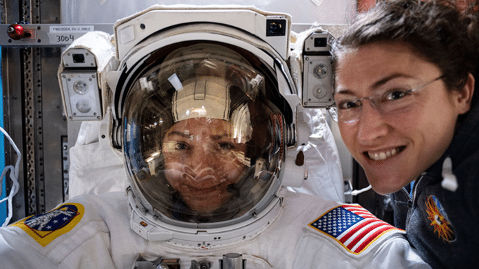 NASA astronaut Christina Koch (right) poses for a portrait with fellow Expedition 61 Flight Engineer Jessica Meir of NASA who is inside a U.S. spacesuit for a fit check.