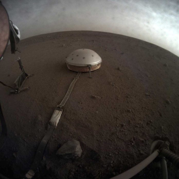 Clouds drift over the dome-covered seismometer, known as SEIS, belonging to NASA's InSight lander, on Mars. Credits: NASA/JPL-Caltech
