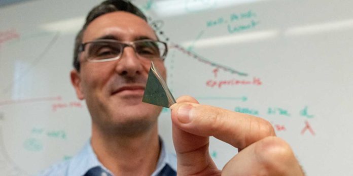 UVM scientist Frederic Sansoz holds a sliver of the world’s strongest silver. The new form of metal is part of a discovery that could launch technological advances from lighter airplanes to better solar panels. (Photograph by Joshua Brown)
