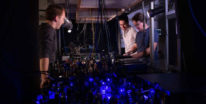 Pictured above: Adam Shaw, Ivaylo Madjarov and Manuel Endres work on their laser-based apparatus at Caltech. Image credit: Caltech
