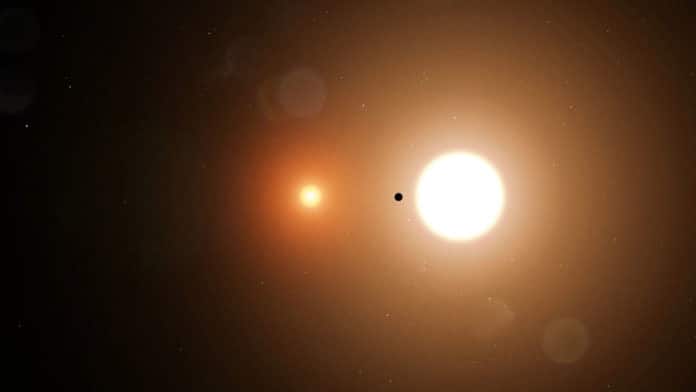 TOI 1338 b is silhouetted by its host stars. TESS only detects transits from the larger star. Credit: NASA's Goddard Space Flight Center/Chris Smith