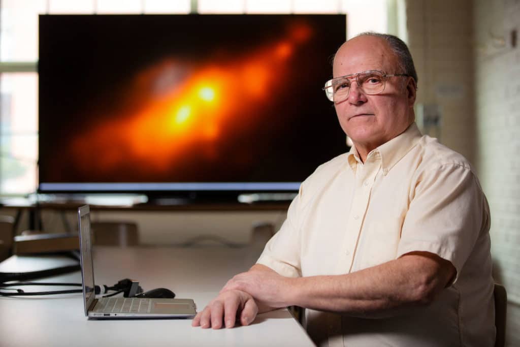 Allen Lawrence, a 77-year-old who earned an Iowa State master's degree in astrophysics in 2018, is first author of a paper revealing a rare double-nucleus structure in a well-known, nearby galaxy. Larger photo. Photo by Christopher Gannon.