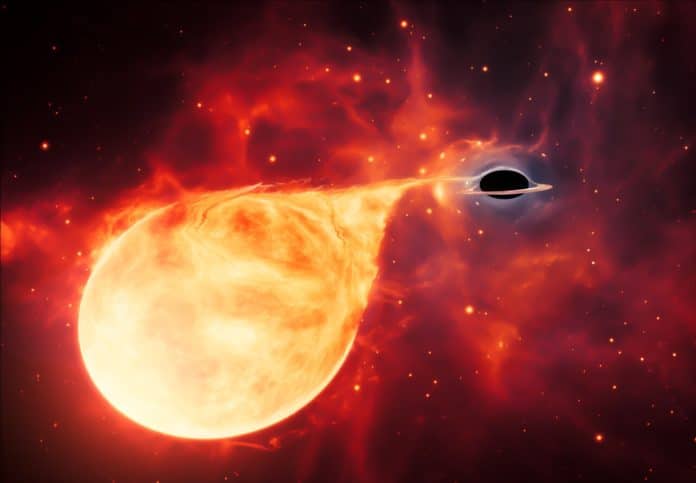 This artist’s impression depicts a star being torn apart by an intermediate-mass black hole (IMBH), surrounded by an accretion disc. This thin, rotating disc of material consists of the leftovers of a star which was ripped apart by the tidal forces of the black hole.