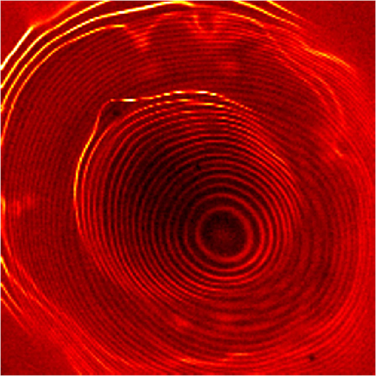 Image of a novel system of coupled quantum dots taken with a scanning tunneling microscope shows electrons orbiting within two concentric sets of closely spaced rings, separated by a gap. The inner set of rings represents one quantum dot; the outer, brighter set represents a larger, outer quantum dot. Credit: NIST
