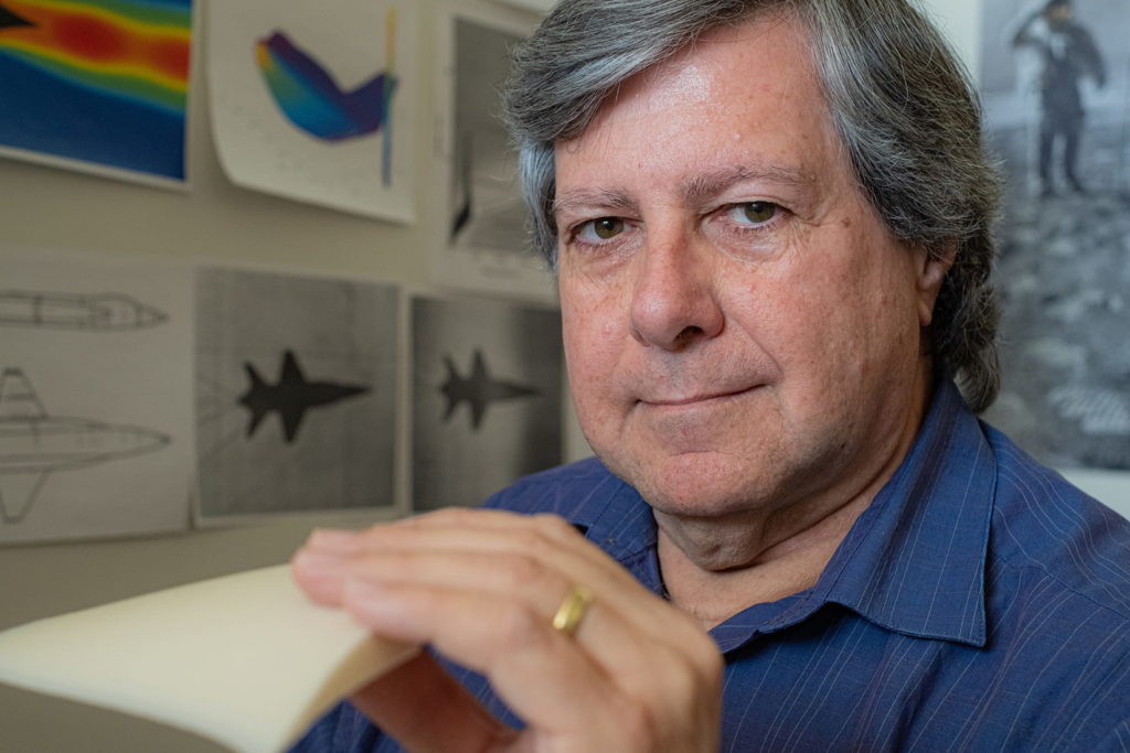  Rice Engineering Professor Patrick Rodi with a 3D printed model of the “capsule waverider,” a hypersonic vehicle he designed to glide like a surfer on its own shock wave. (Photo by Jeff Fitlow/Rice University)