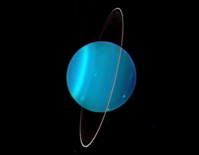 Uranus is uniquely tipped over among the planets in our Solar System. Uranus' moons and rings are also orientated this way, suggesting they formed during a cataclysmic impact which tipped it over early in its history. Credit: Lawrence Sromovsky, University of Wisconsin-Madison/W.W. Keck Observatory/NASA