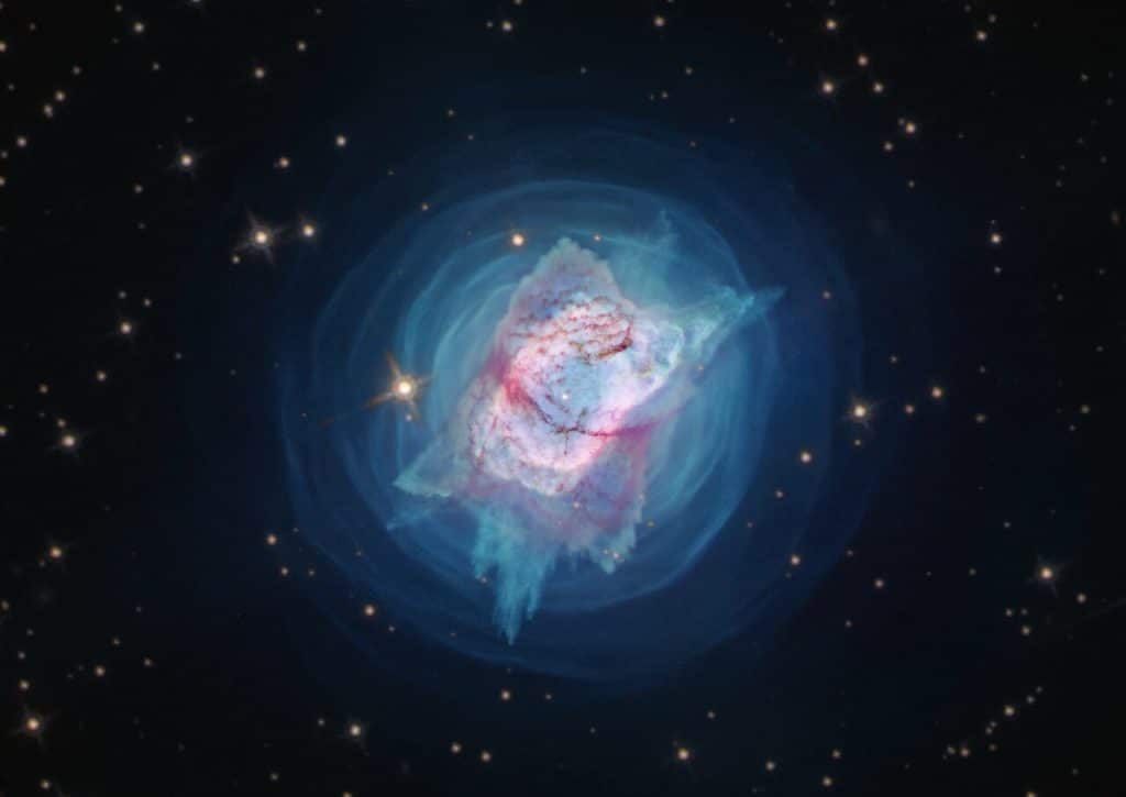 This image from the NASA/ESA Hubble Space Telescope depicts NGC 7027, or the “Jewel Bug” nebula.  The object had been slowly puffing away its mass in quiet, spherically symmetric or perhaps spiral patterns for centuries — until relatively recently when it produced a new cloverleaf pattern. New observations of the object have found unprecedented levels of complexity and rapid changes in the jets and gas bubbles blasting off of the star at the centre of the nebula.