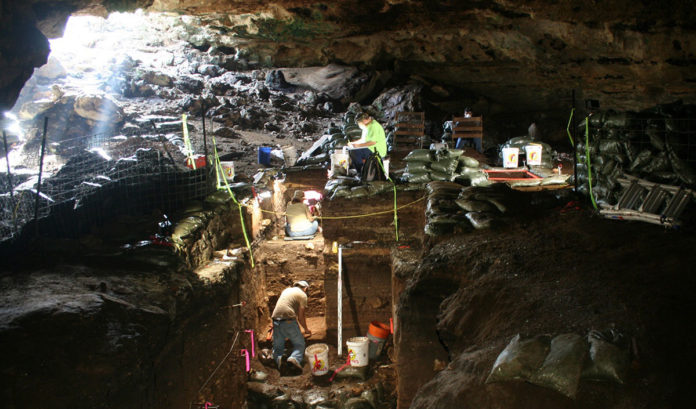 Workers excavating Hall Cave in Central Texas