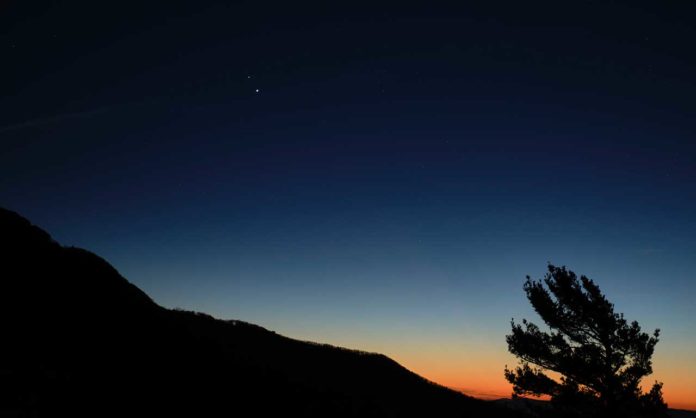 Saturn, top, and Jupiter, below, are seen after sunset from Shenandoah National Park, Sunday, Dec. 13, 2020, in Luray, Virginia