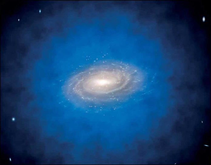 Artist’s impression of a spiral galaxy embedded in a larger distribution of invisible dark matter, known as a dark matter halo