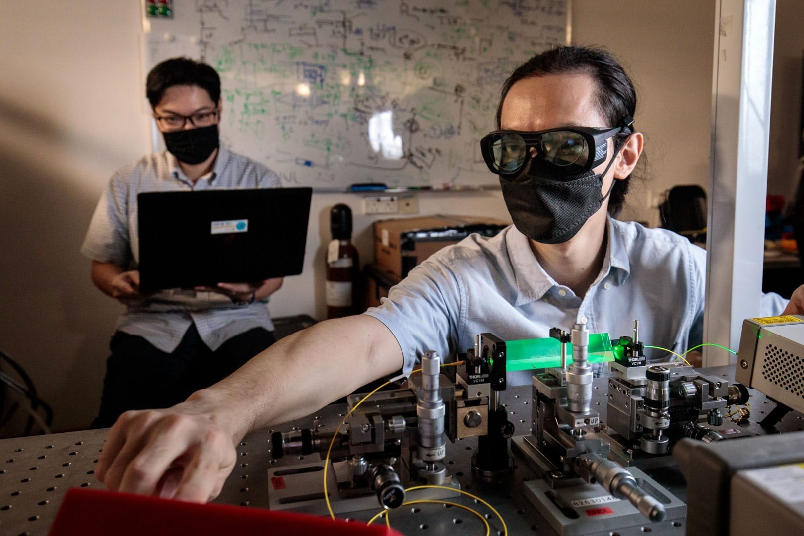 Assistant Professor Charles Lim (back) and Dr Zhang Gong (front) with their team’s first-of its-kind quantum power limiter device. Credit: National University of Singapore