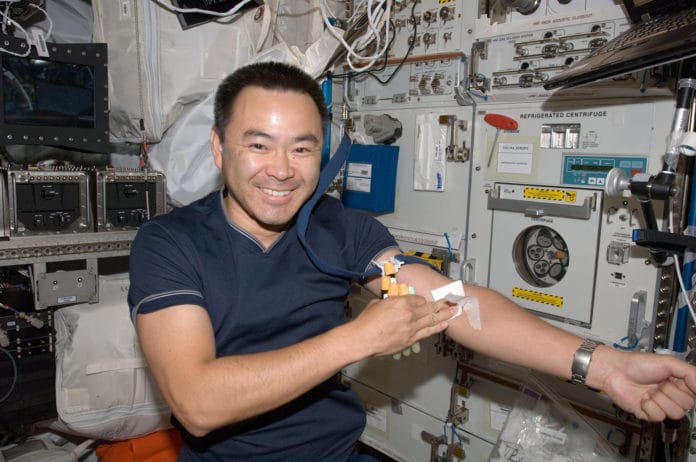 Japanese Aerospace Exploration Agency astronaut Akihiko Hoshide poses for a photo after undergoing a generic blood draw in the European Laboratory/Columbus Orbital Facility (COF).