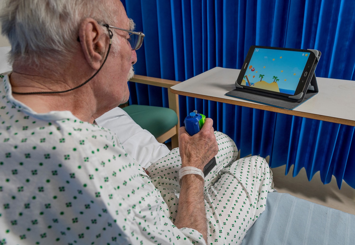 Image showing old man holding rehab device